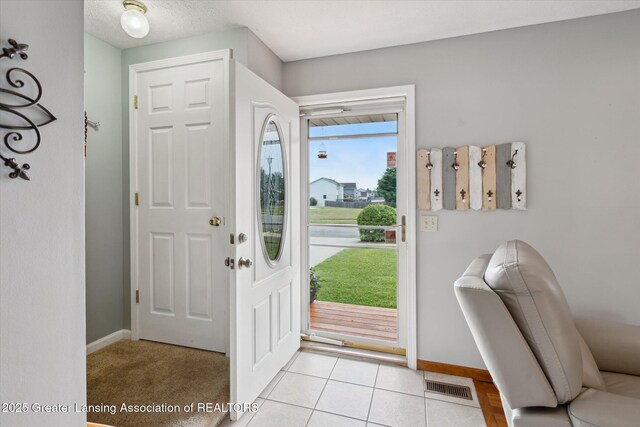 129 Elizabeth Way, Potterville, MI 48876 - foyer featuring baseboards and light tile patterned floors