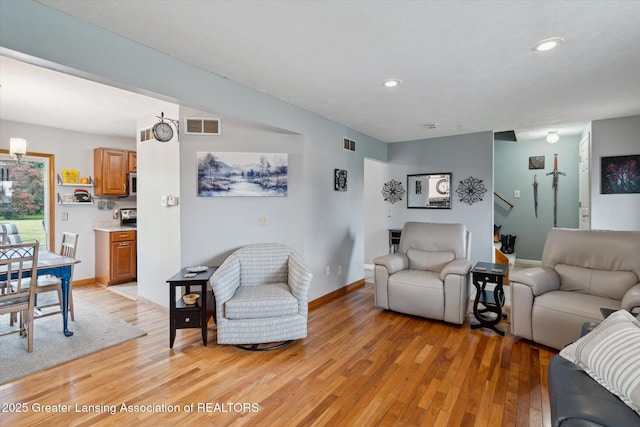 129 Elizabeth Way, Potterville, MI 48876 - living room with light wood-type flooring, recessed lighting, and stairway