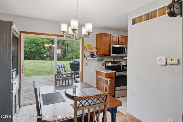 129 Elizabeth Way, Potterville, MI 48876 - dining room with a chandelier and light wood-type flooring