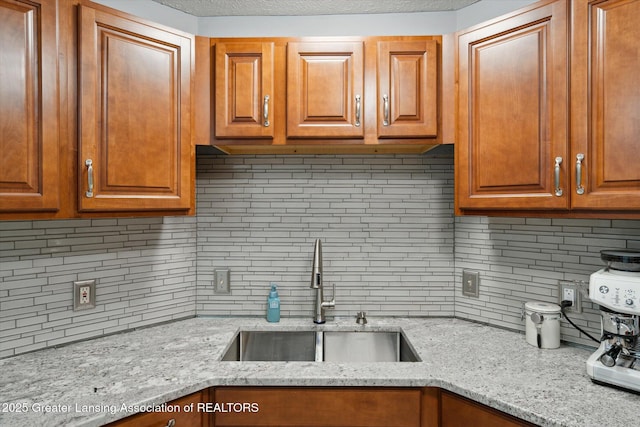 129 Elizabeth Way, Potterville, MI 48876 - kitchen with decorative backsplash, light stone countertops, and brown cabinetry
