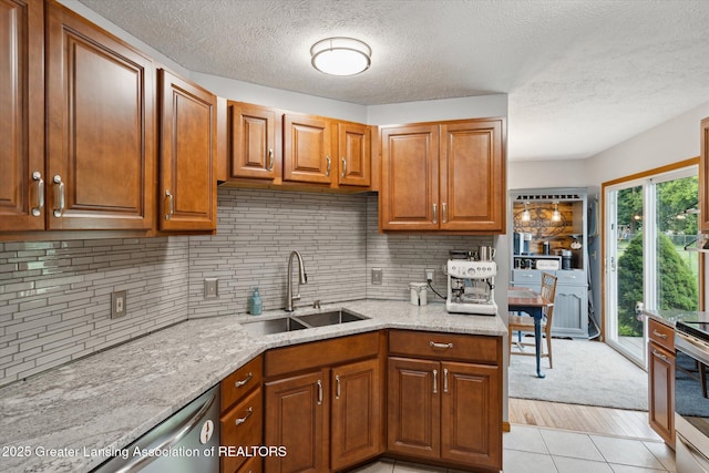 129 Elizabeth Way, Potterville, MI 48876 - kitchen with brown cabinetry, a textured ceiling, light stone counters, and decorative backsplash