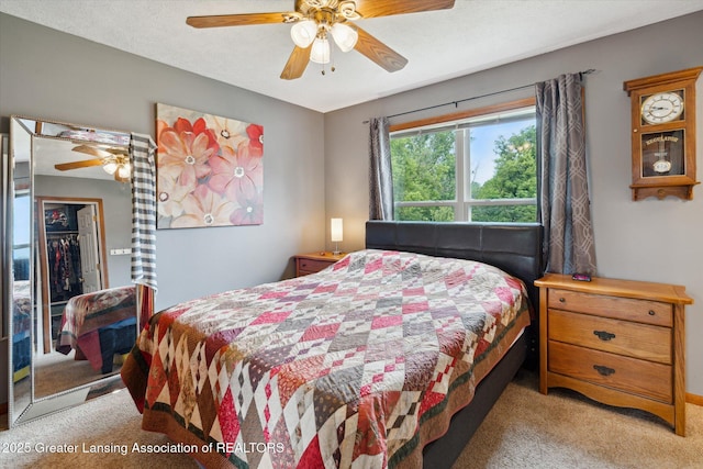 129 Elizabeth Way, Potterville, MI 48876 - bedroom with light carpet, ceiling fan, and a closet