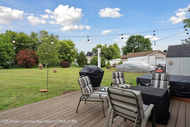 129 Elizabeth Way, Potterville, MI 48876 - wooden terrace featuring a grill, a lawn, and a storage unit