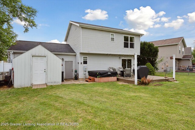 129 Elizabeth Way, Potterville, MI 48876 - back of house featuring a hot tub and a storage shed