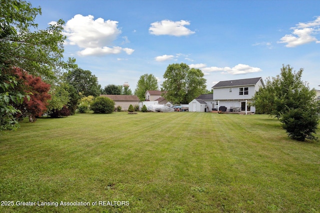 129 Elizabeth Way, Potterville, MI 48876 - view of green lawn featuring a shed