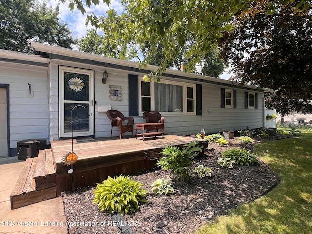 709 N Mead St, Saint Johns, MI 48879 - view of front facade featuring a deck