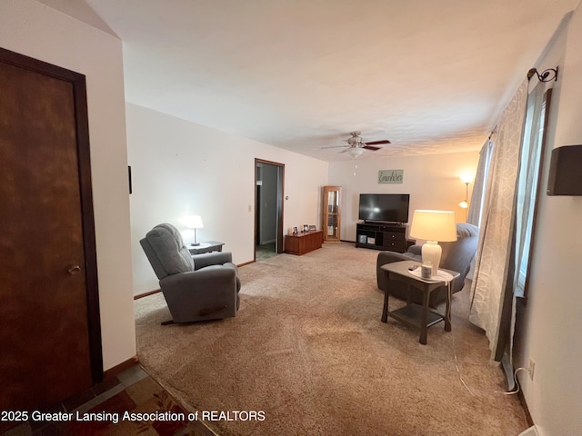 709 N Mead St, Saint Johns, MI 48879 - carpeted living area featuring a ceiling fan and baseboards