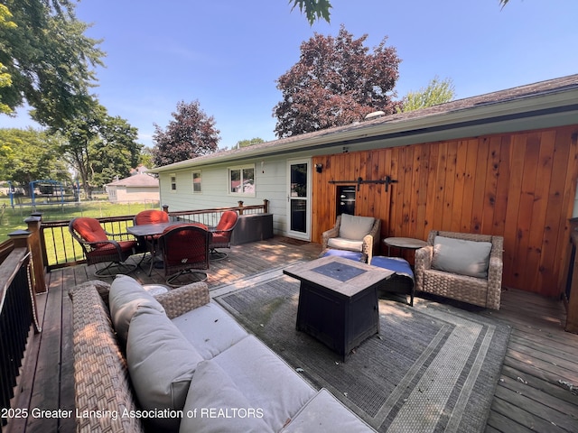 709 N Mead St, Saint Johns, MI 48879 - deck featuring an outdoor living space with a fire pit and outdoor dining area