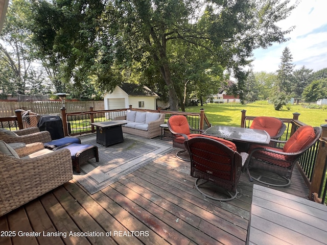 709 N Mead St, Saint Johns, MI 48879 - wooden terrace featuring outdoor dining space, a shed, and an outdoor living space with a fire pit