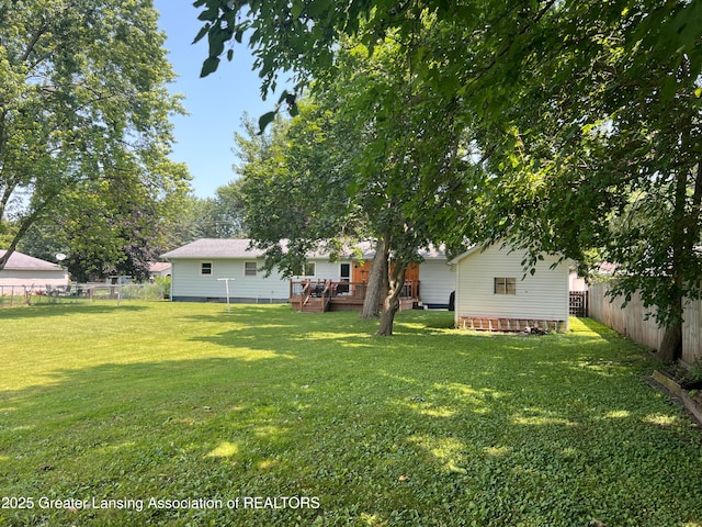 709 N Mead St, Saint Johns, MI 48879 - fenced backyard with a wooden deck