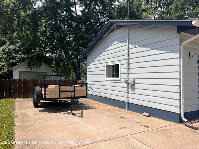 709 N Mead St, Saint Johns, MI 48879 - view of side of property with a detached garage and a patio