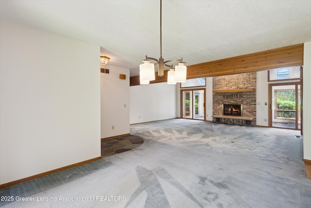 2575 Capeside Dr, Okemos, MI 48864 - unfurnished living room featuring carpet floors, a chandelier, healthy amount of natural light, and a fireplace