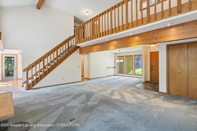 2575 Capeside Dr, Okemos, MI 48864 - unfurnished living room with high vaulted ceiling, carpet floors, stairway, healthy amount of natural light, and beamed ceiling