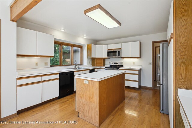 2575 Capeside Dr, Okemos, MI 48864 - kitchen with stainless steel appliances, light countertops, light wood-type flooring, white cabinetry, and recessed lighting