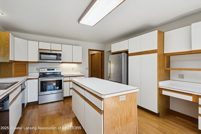 2575 Capeside Dr, Okemos, MI 48864 - kitchen featuring stainless steel appliances, light wood-style floors, and light countertops