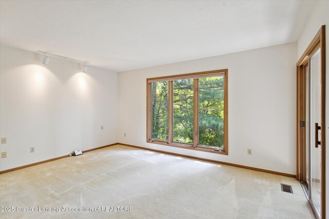 2575 Capeside Dr, Okemos, MI 48864 - unfurnished room with track lighting and light colored carpet