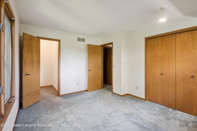2575 Capeside Dr, Okemos, MI 48864 - unfurnished bedroom featuring a closet and light colored carpet