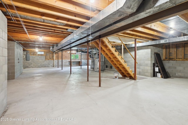 2575 Capeside Dr, Okemos, MI 48864 - basement with electric panel, stairway, and water heater