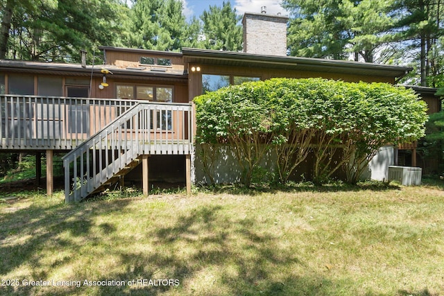 2575 Capeside Dr, Okemos, MI 48864 - back of property featuring a chimney, a deck, a lawn, and stairway