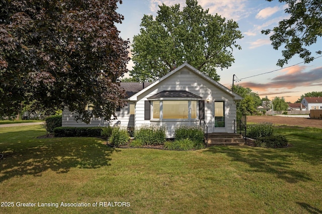 873 Union Ave, Owosso, MI 48867 - view of front facade with a yard and a shingled roof