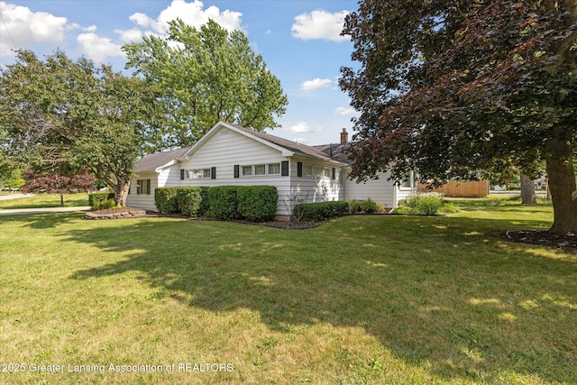873 Union Ave, Owosso, MI 48867 - view of property exterior with a lawn and a chimney
