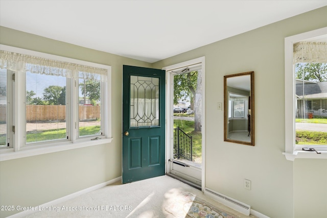 873 Union Ave, Owosso, MI 48867 - foyer with healthy amount of natural light, a baseboard heating unit, and light colored carpet