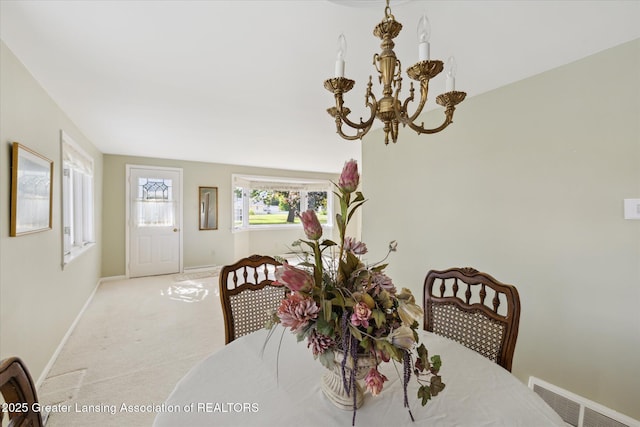 873 Union Ave, Owosso, MI 48867 - dining space with a chandelier and carpet flooring
