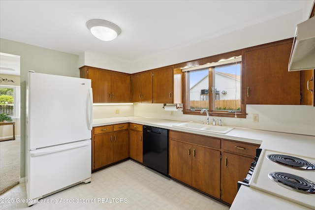 873 Union Ave, Owosso, MI 48867 - kitchen with white appliances, light countertops, brown cabinetry, and light flooring