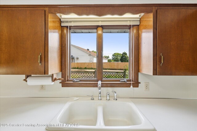 873 Union Ave, Owosso, MI 48867 - kitchen featuring light countertops and brown cabinetry