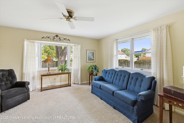 873 Union Ave, Owosso, MI 48867 - carpeted living area featuring ceiling fan and baseboards
