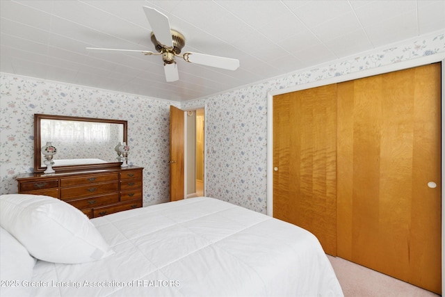 873 Union Ave, Owosso, MI 48867 - carpeted bedroom with wallpapered walls, a closet, and ceiling fan