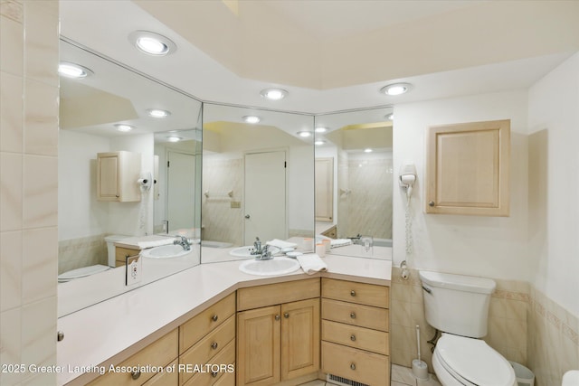 873 Union Ave, Owosso, MI 48867 - full bathroom featuring tile walls, vanity, a shower, a wainscoted wall, and recessed lighting