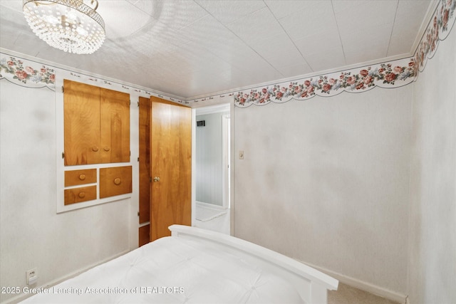 873 Union Ave, Owosso, MI 48867 - bedroom featuring baseboards and a chandelier
