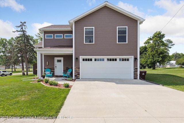 112 E Barber St, Ithaca, MI 48847 - traditional home with a garage, a front yard, and driveway