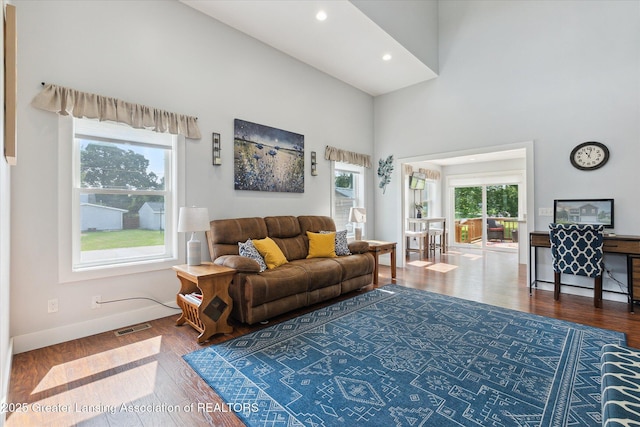 112 E Barber St, Ithaca, MI 48847 - living area featuring wood finished floors, a high ceiling, and recessed lighting