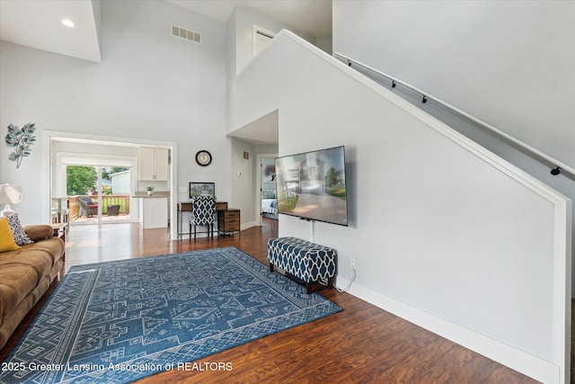 112 E Barber St, Ithaca, MI 48847 - living room with wood finished floors, a towering ceiling, and recessed lighting