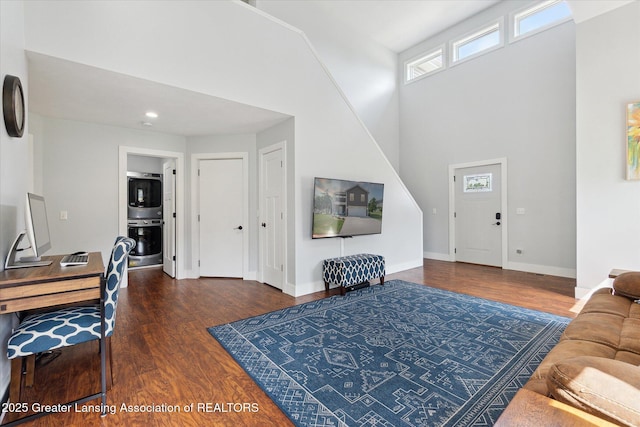 112 E Barber St, Ithaca, MI 48847 - living room with wood finished floors, a towering ceiling, and recessed lighting