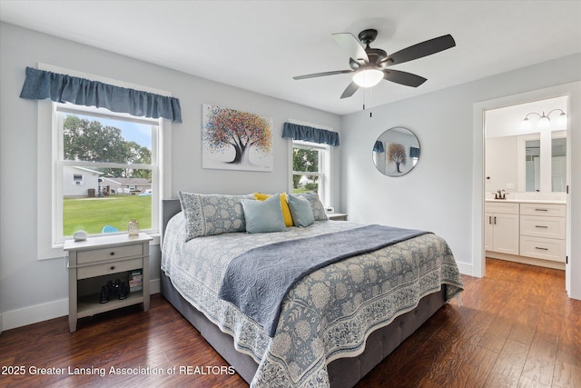 112 E Barber St, Ithaca, MI 48847 - bedroom with dark wood-style floors, ensuite bath, and a ceiling fan