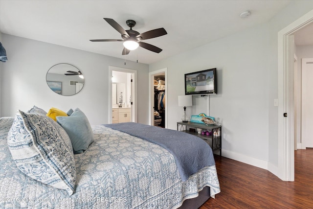 112 E Barber St, Ithaca, MI 48847 - bedroom featuring wood finished floors, a walk in closet, ceiling fan, and connected bathroom