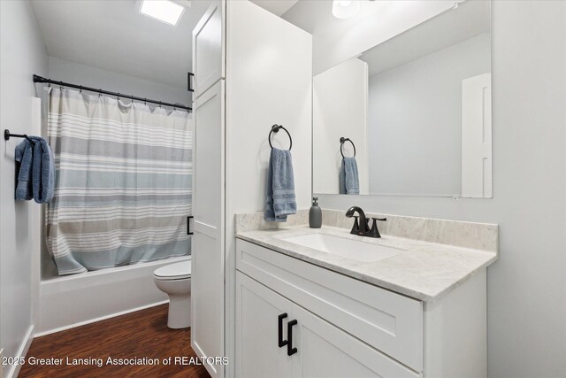 112 E Barber St, Ithaca, MI 48847 - bathroom with vanity, wood finished floors, and shower / bathtub combination with curtain