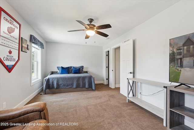 112 E Barber St, Ithaca, MI 48847 - carpeted bedroom with baseboards and ceiling fan