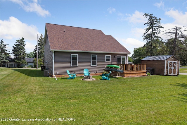 112 E Barber St, Ithaca, MI 48847 - rear view of property with a deck, a storage shed, a yard, and roof with shingles
