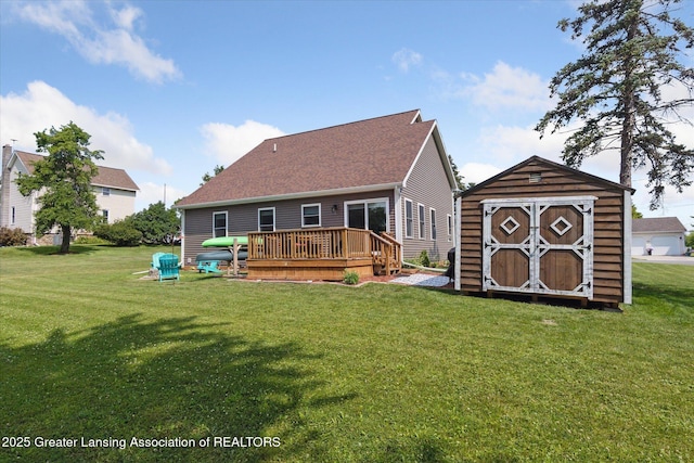 112 E Barber St, Ithaca, MI 48847 - rear view of house featuring a storage unit, a wooden deck, and a yard