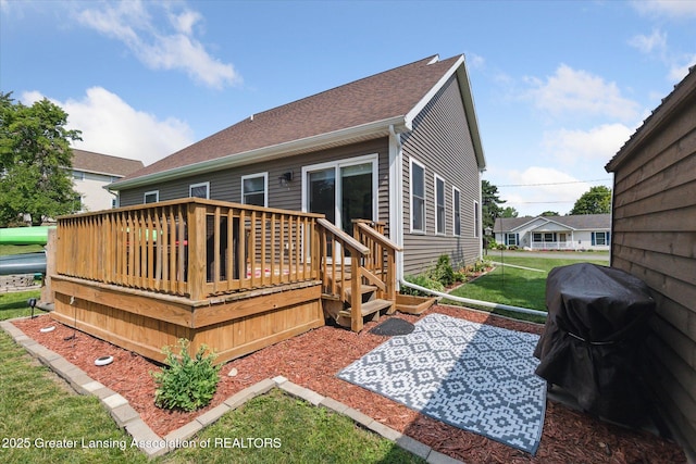 112 E Barber St, Ithaca, MI 48847 - rear view of property featuring a deck and a lawn