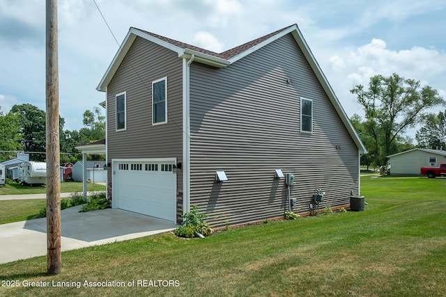 112 E Barber St, Ithaca, MI 48847 - view of home's exterior with a garage, driveway, and a lawn