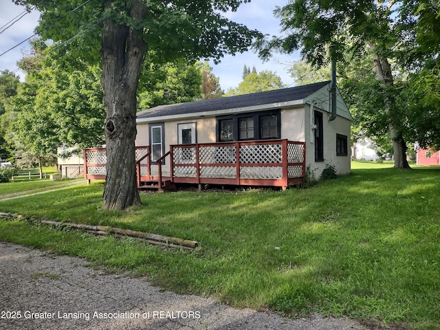 518 Clark St, Eaton Rapids, MI 48827 - view of front of house with a wooden deck and a front yard