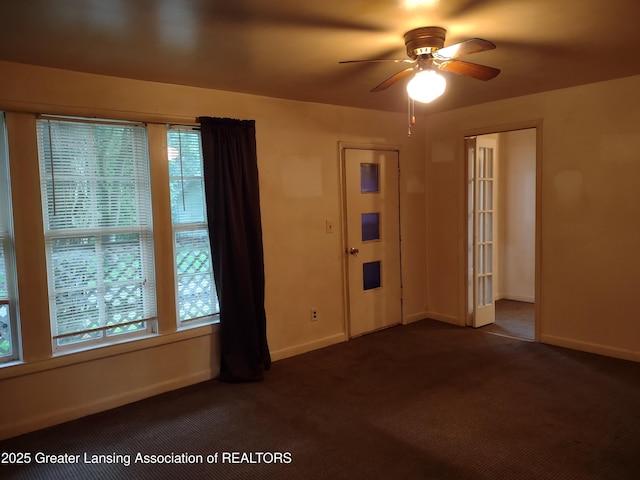 518 Clark St, Eaton Rapids, MI 48827 - spare room with ceiling fan, dark carpet, and healthy amount of natural light