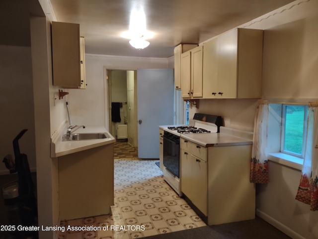 518 Clark St, Eaton Rapids, MI 48827 - kitchen with white range with gas cooktop, light flooring, and light countertops
