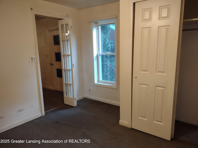 518 Clark St, Eaton Rapids, MI 48827 - unfurnished bedroom featuring dark colored carpet and baseboards
