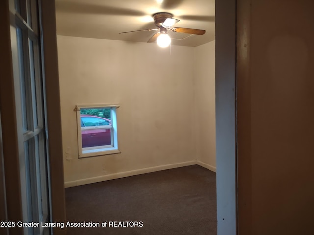 518 Clark St, Eaton Rapids, MI 48827 - empty room featuring dark colored carpet and a ceiling fan